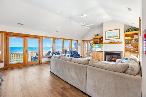 a living room with a couch and a fireplace at 6120 - Yankee Clipper in Nags Head