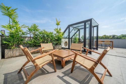 a group of chairs and a table on a patio at Grey Stones - Private Pool Villa with Rooftop in Ungasan
