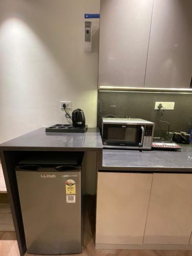 a kitchen with a toaster oven and a microwave at LaCasa Heights in Greater Noida