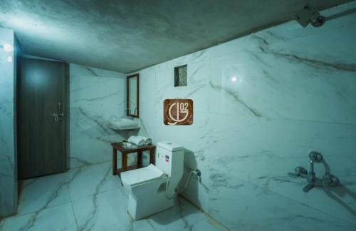 a white marble bathroom with a sink and a toilet at Gj02 desert resort in Jaisalmer