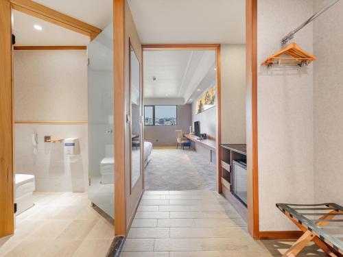 a bathroom with a shower and a toilet at CHECK inn Select Tainan Yongkang in Yongkang
