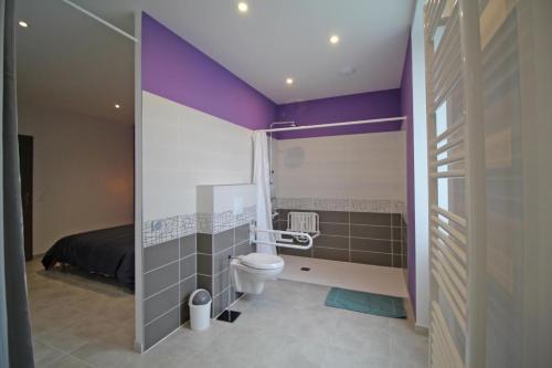 a bathroom with a toilet and a bed in it at La reille in Cussac