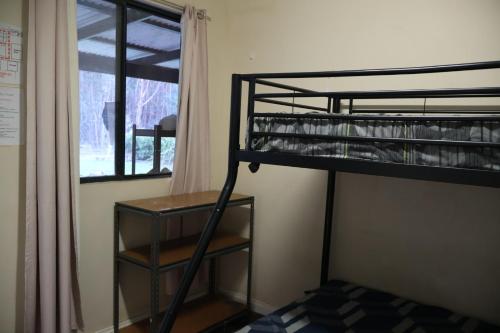 a bunk bed in a room with a window at Normalee manor hostel in Deanmill