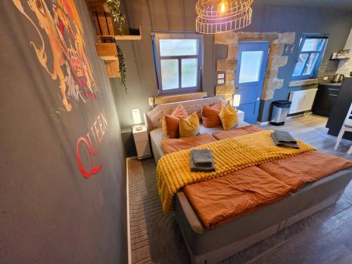 a bedroom with two beds with orange comforters at Gemütliches Studio in Dresden-zentrumsnah in Dresden