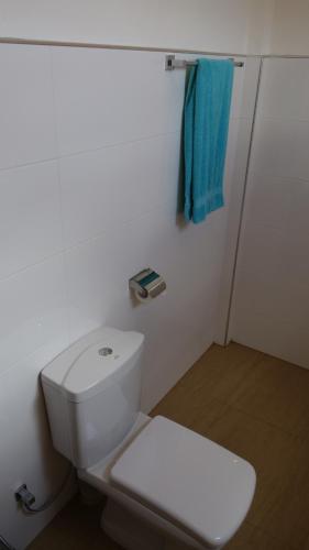 a bathroom with a white toilet and a blue towel at Salt Lake Cabanas & Restaurant in Tangalle