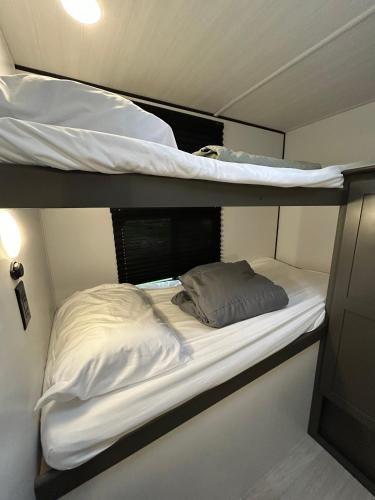 two bunk beds in a small room at The Bunkhouse Camper in Klamath