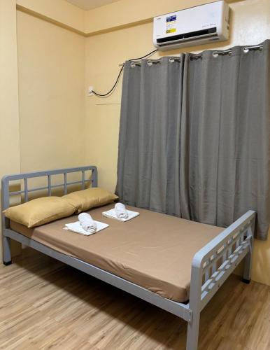 a bed in a room with a curtain at Three Bedrooms Two Storey Home with Parking in Santa Rosa