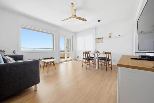 a living room with a couch and a table at Vista Roses Mar - Ariadna in Roses