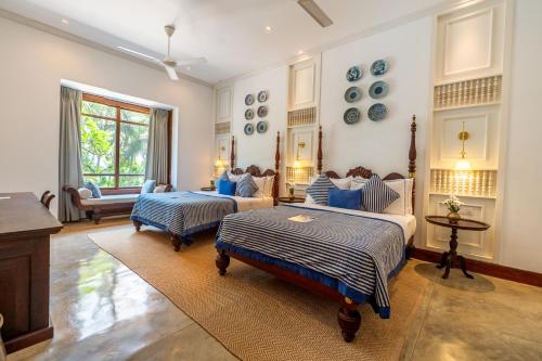 a large living room with two beds and a couch at The Villa by Contemporary Ceylon in Wadduwa