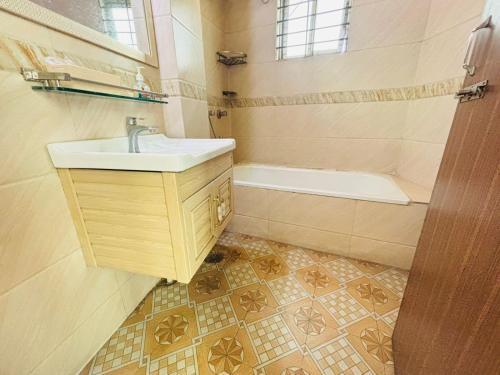 a bathroom with a sink and a bath tub at Hotel Progati Inn Ltd. in Dhaka