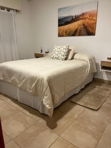 a bedroom with a bed and a painting on the wall at Las Lomitas in Lincoln