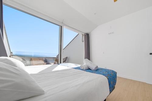 a bedroom with a bed and a large window at Vista Roses Mar - El Brancs in Roses