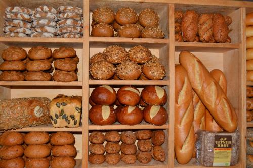 a display of different types of bread and pastries at Arosea Life Balance Hotel in Santa Valburga St. Walburg