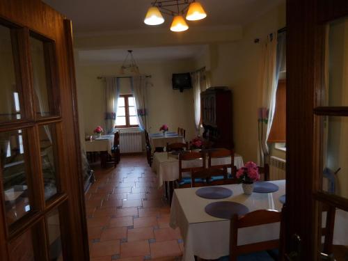 a dining room with tables and chairs and a window at Casa de Hóspedes Celeste by Portugalferias in Odeceixe