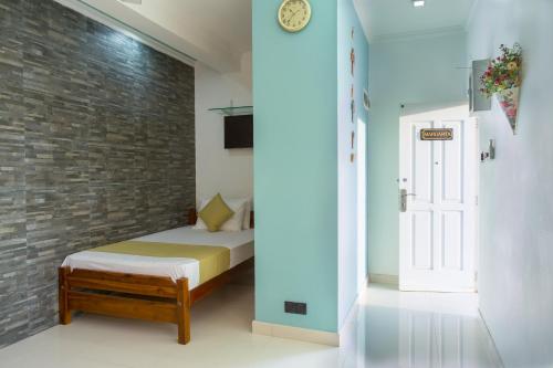 a bedroom with a bed and a brick wall at Shalom Residence Kandy in Kandy