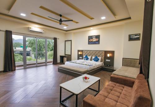 a living room with a bed and a couch at Serenity Hill Resort Near 2Km Fateh Sagar Lake Udaipur in Udaipur