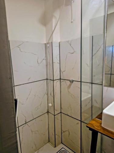 a bathroom with a shower and a sink at Casas Container Cassino in Rio Grande