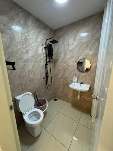 a bathroom with a toilet and a sink at SeFA Cozy Stay in Malacca
