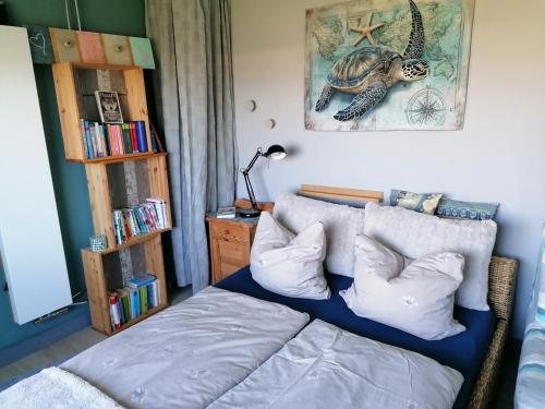 a bedroom with a bed and a book shelf at Tinyhouse CARPE DIEM in Dirkshorn