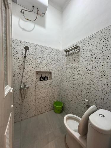 a bathroom with a shower and a toilet in it at Clamitan House Padalarang in Padalarang