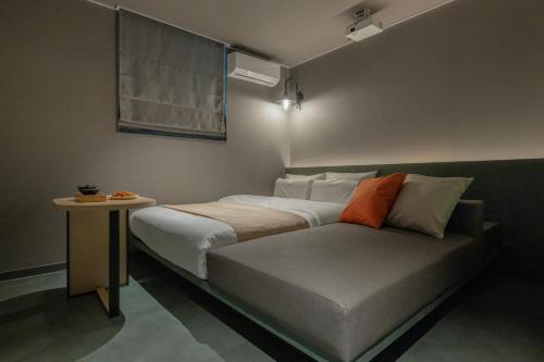 a bedroom with a bed and a side table at Anook Hotel Suwon Ingye 2 in Suwon