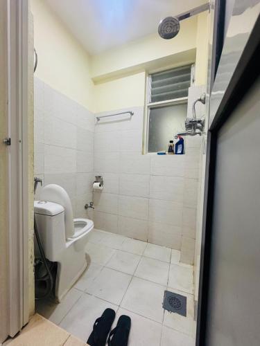 a bathroom with a toilet and a window at Kattel HomeStay And Apartments in Bālāju