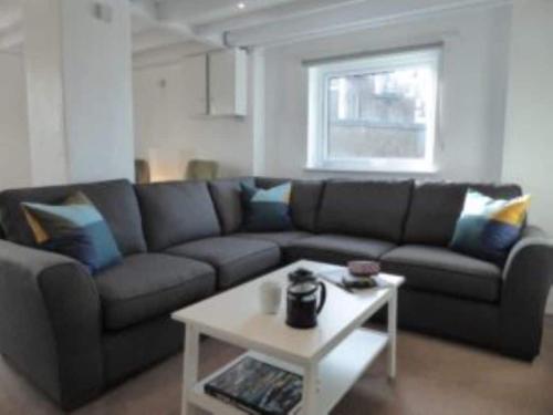 a living room with a couch and a table at Rhiw in Llangian