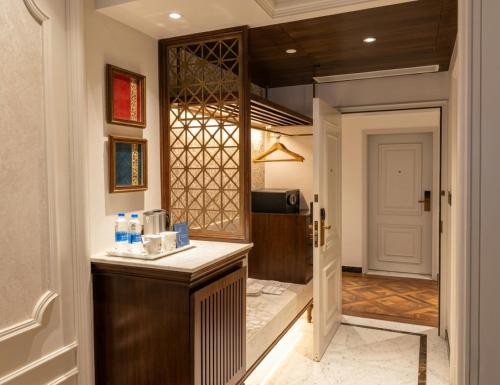 a kitchen with a counter and a door to a room at Noor-Us-Sabah Palace in Bhopal