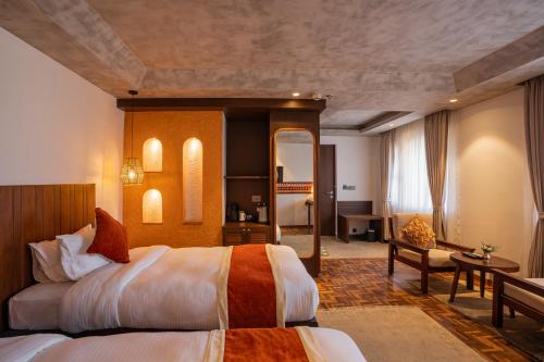 a hotel room with a bed and a desk at Dhulikhel Mountain Resort in Dhulikhel