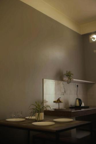 a kitchen with a counter with two plates on it at HO6 Homestay in Guwahati