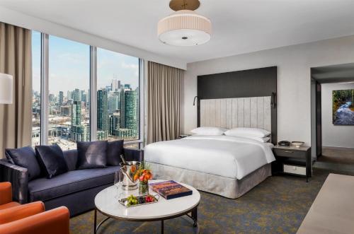 a hotel room with a bed and a couch at Hotel X Toronto, a Destination by Hyatt Hotel in Toronto