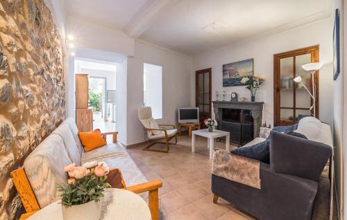 a living room with a couch and a fireplace at Puresa in Artá