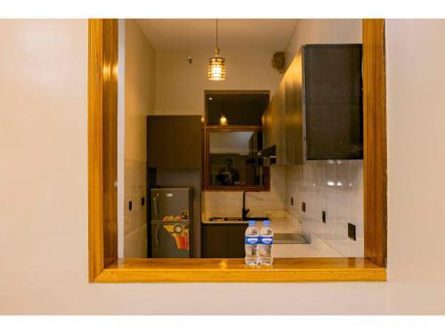 two bottles of water sitting on a counter in a kitchen at Residency by Mozette Kigali in Kigali