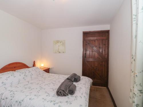 a bedroom with a bed with a towel on it at The Cowshed in Bristol