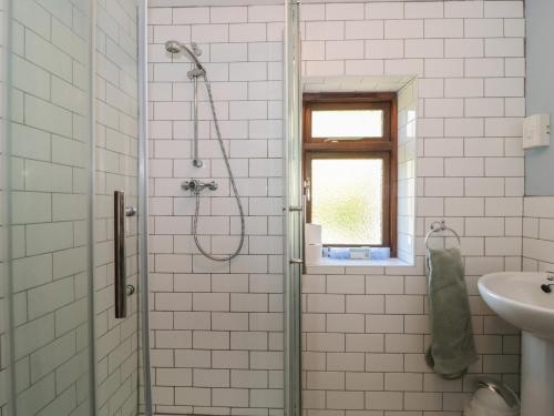 a bathroom with a shower and a sink at The Cowshed in Bristol
