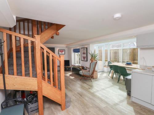 a kitchen and dining room with a staircase in a house at Kiloran in Rhosneigr