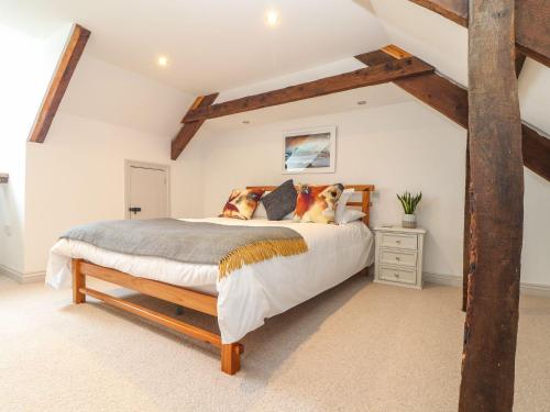 a bedroom with a large bed in a attic at Ty Bryn in Marazion