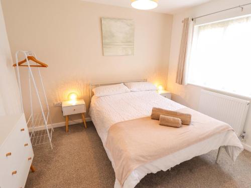 a bedroom with a bed with two towels on it at Field View in North Walsham