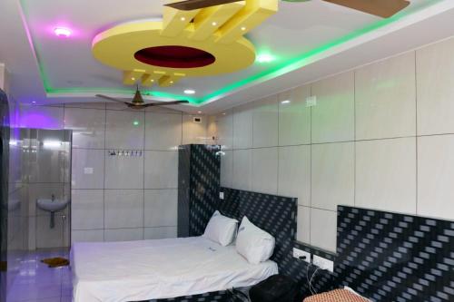 a bedroom with a bed and a ceiling fan at Abidharpp in Velankanni