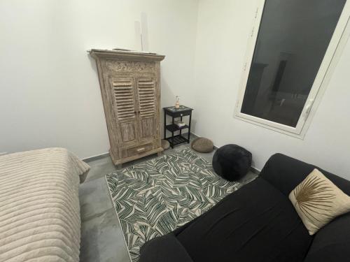 a living room with a couch and a window at Arche du cap de bonne esperance in Sainte-Rose
