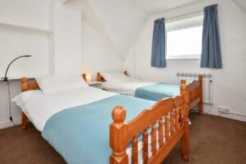 a bedroom with two beds and a window at Cilan in Llangian