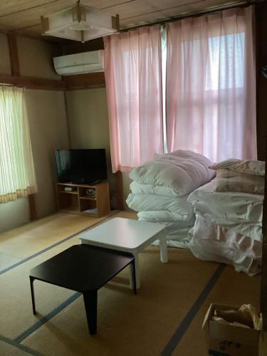 a living room with a couch and a coffee table at Strawberry villa in Ichihara