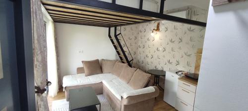 a living room with a couch and a table at Iskra Tiny House in Podgorica