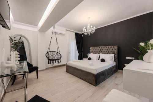 a bedroom with a bed and a chandelier at Solena Villa in Stavromenos