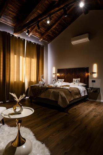 a bedroom with a large bed and a table at B&B er in Isola del Liri
