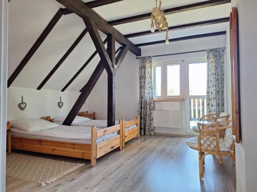 a bedroom with a wooden bed and a window at Powrócisz tu... in Sorkwity