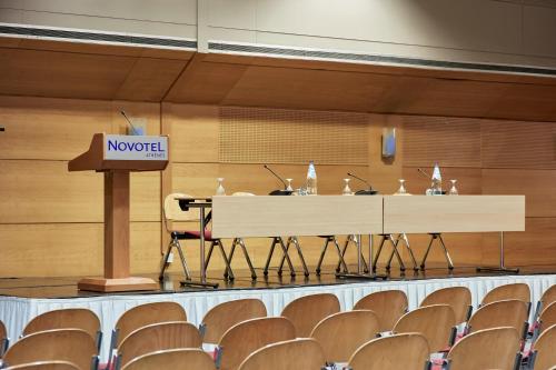 a podium in an auditorium with a novation sign on it at Novotel Athens in Athens