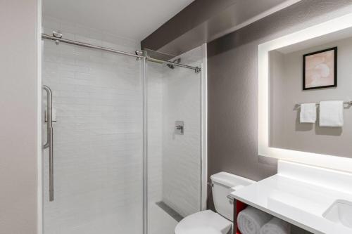 a bathroom with a shower and a toilet and a sink at Hawthorn Extended Stay by Wyndham Jackson in Jackson