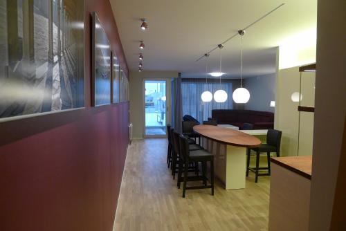a dining room and kitchen with a table and chairs at Liiva Seaside Apartment in Haapsalu