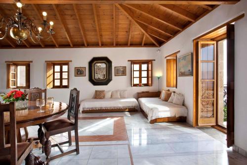 a living room with a couch and a table at Theophano Art Hotel in Monemvasia